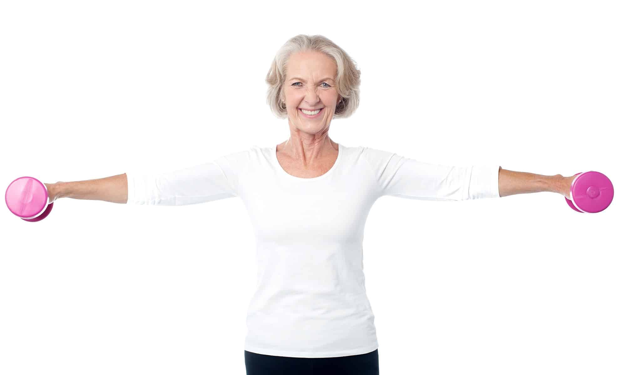 smiling older woman w pink weights - February Newsletter