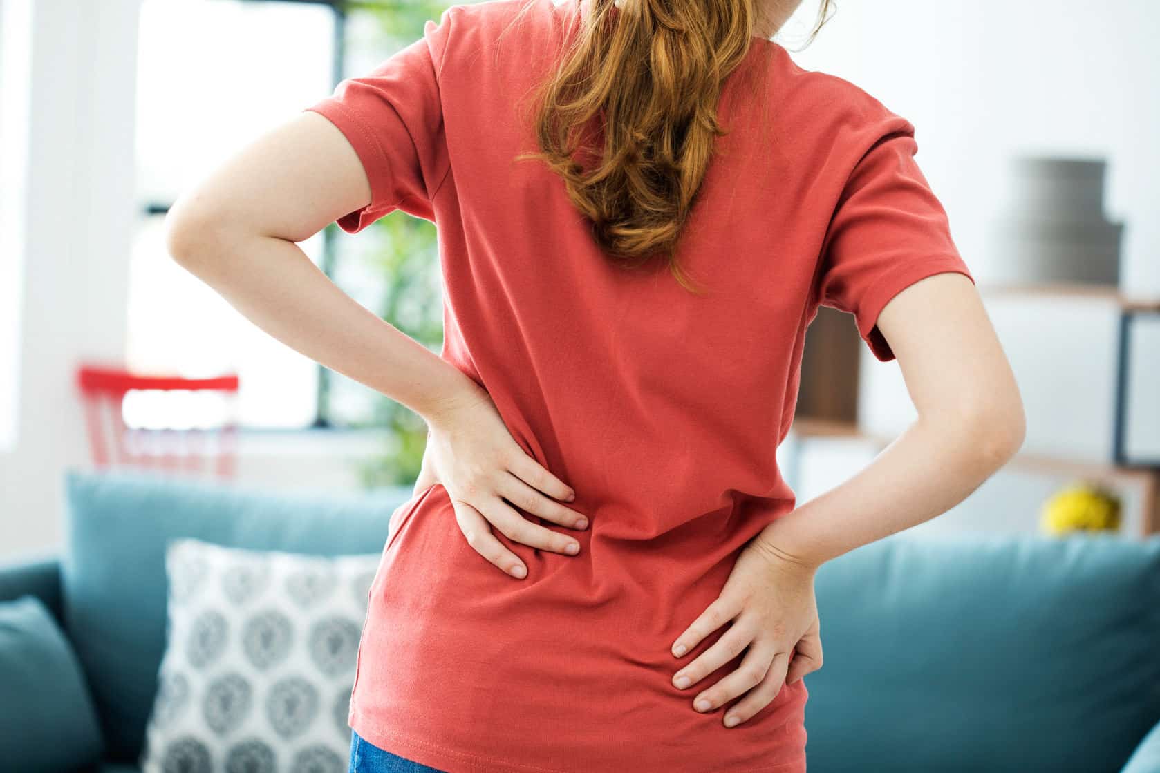 48571 woman lowbackpain red shirt 88262051 ml - What Is Chronic Pain?